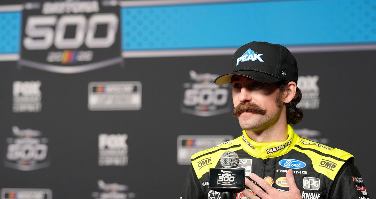 Ryan Blaney looks on.