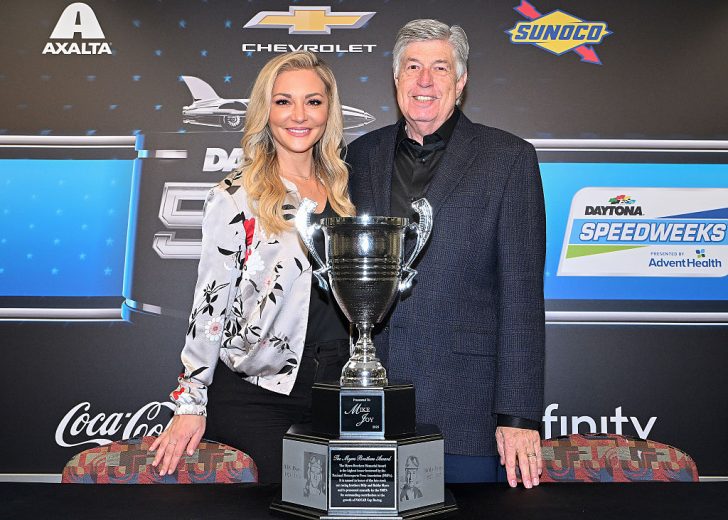 Danielle Trotta and Mike Joy pose for a photo.