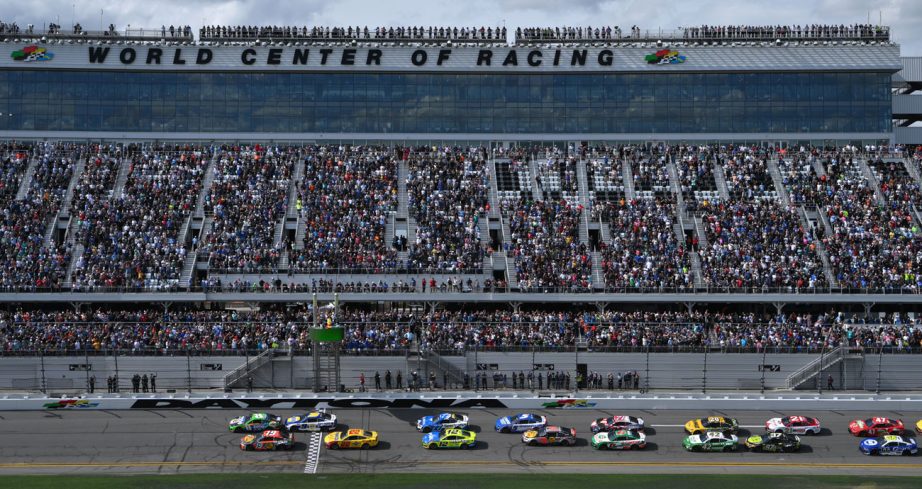 NASCAR Cup Series cars race down the frontstretch at Daytona International Speedway.