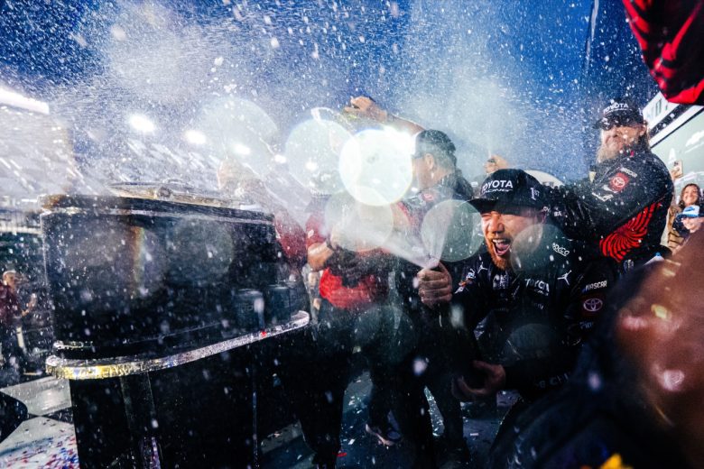 Tyler Reddick sprays victory champagne in Victory Lane.