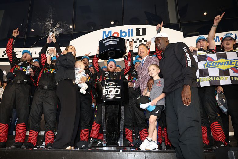 Tyler Reddick, his No. 45 pit crew and his family pose for a photo in Victory Lane.