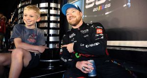 Tyler Reddick and his son Beau show off the latest addition to the Harley J. Earl Trophy