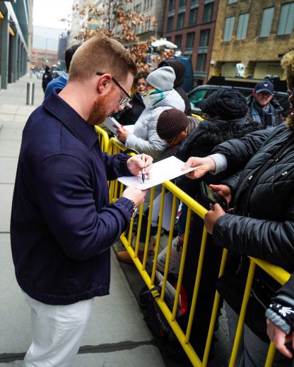 Tyler Reddick signs autographs.