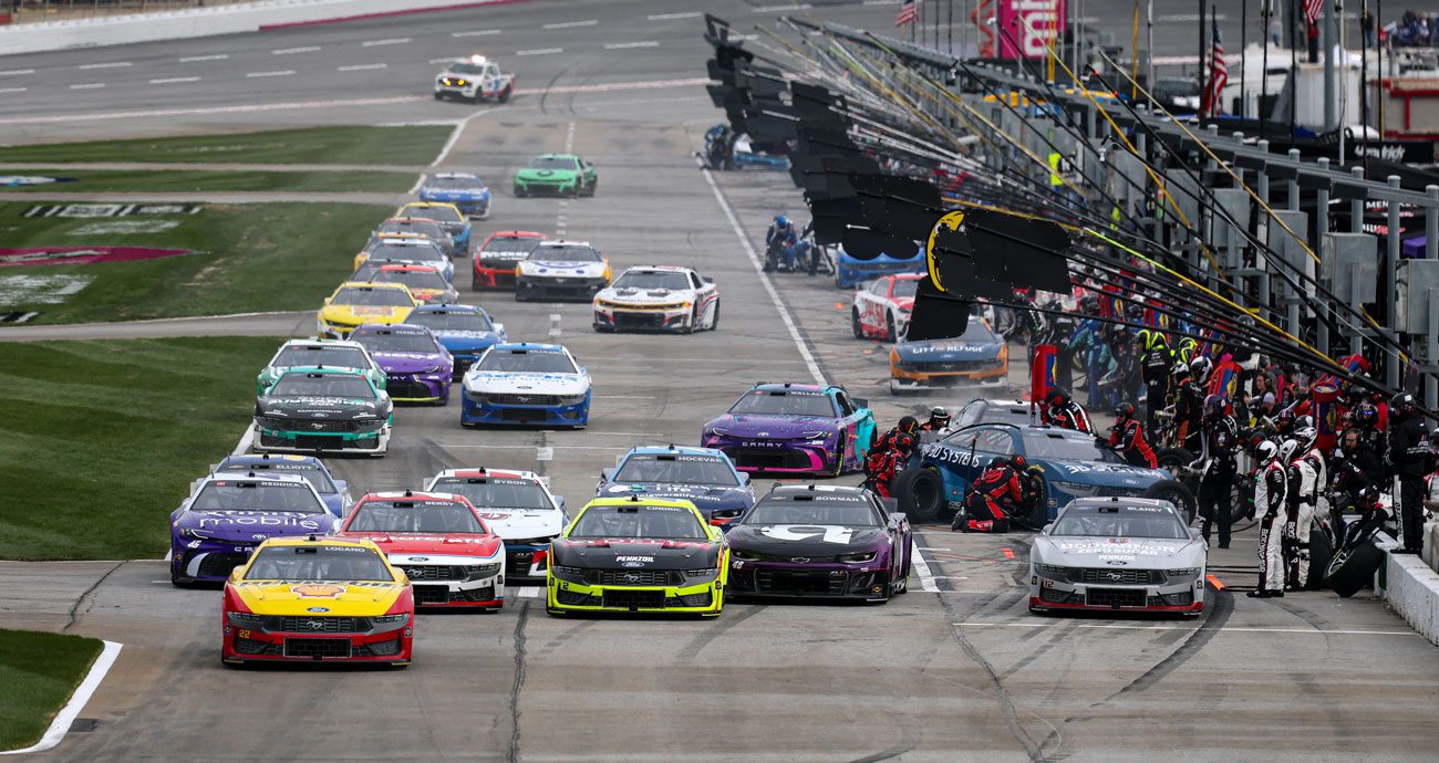 NASCAR Cup Series action on pit road at EchoPark Speedway.