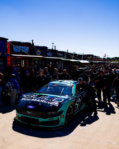 The No. 6 Ford of Brad Keselowski gets pushed to pit road.