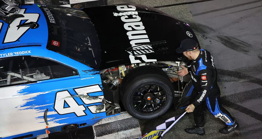 Tyler Reddick celebrates with broken car.