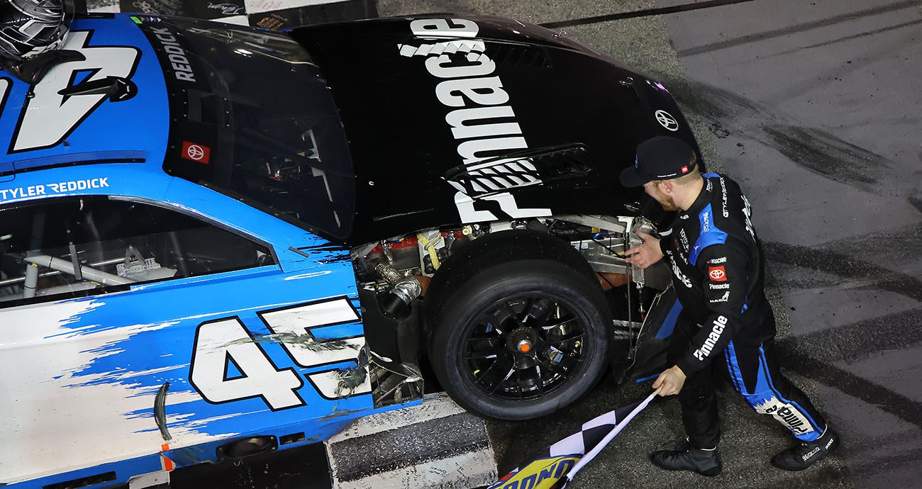 Tyler Reddick celebrates with broken car.