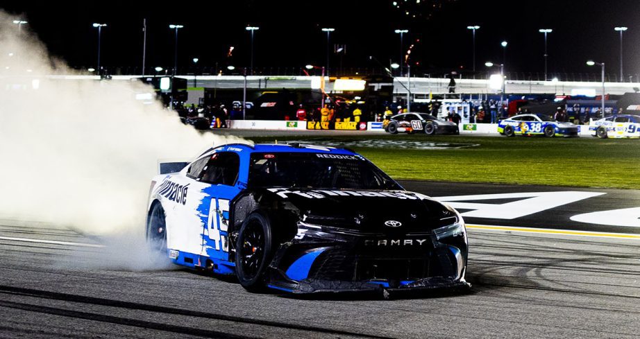 Tyler Reddick does burnout with beat up car.