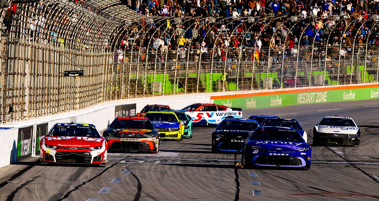 William Byron and Bubba Wallace race for the Stage 2 win while Kyle Larson's No. 5 Chevrolet noses into the outside wall at EchoPark Speedway