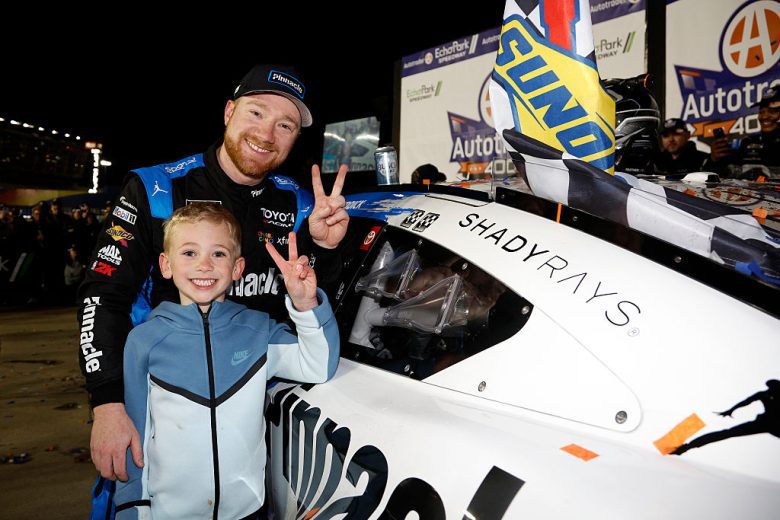 Tyler Reddick and his son, Beau, pose for a photo in Victory Lane.