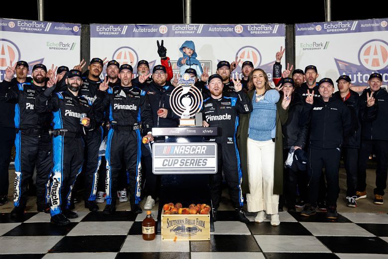 Tyler Reddick and his family and team pose for a photo in Victory Lane.
