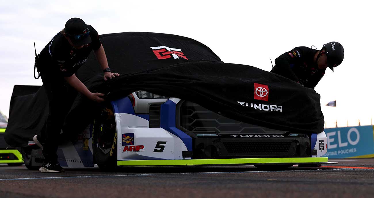 Tricon Garage crew members cover the No. 5 Toyota of Adam Andretti on pit road at St. Petersburg