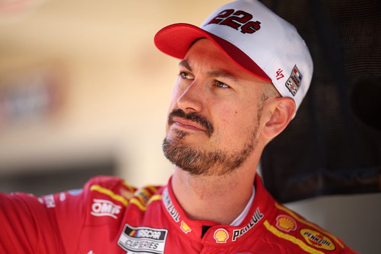 Joey Logano looks on.