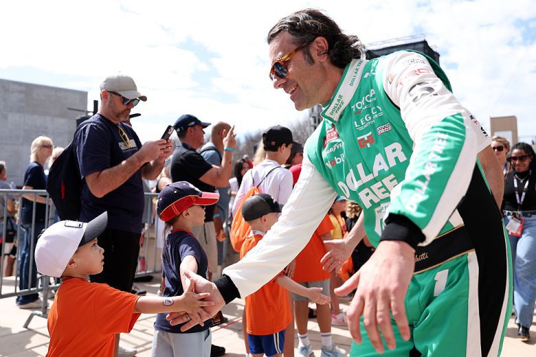 Dario Franchitti greets fans.