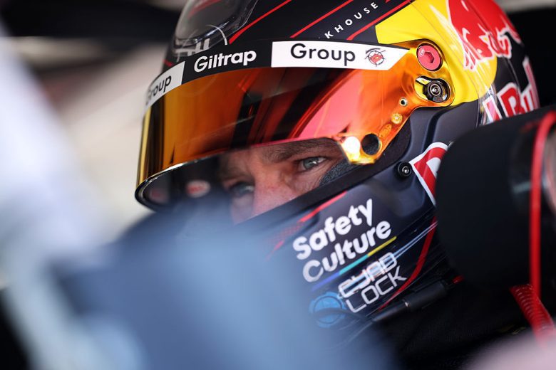 Shane van Gisbergen looks on.