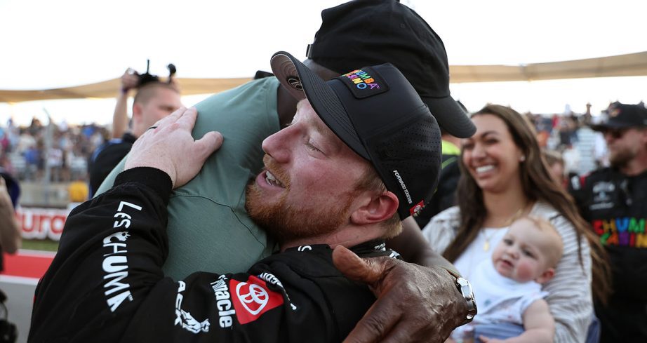 Tyler Reddick hugs Michael Jordan.
