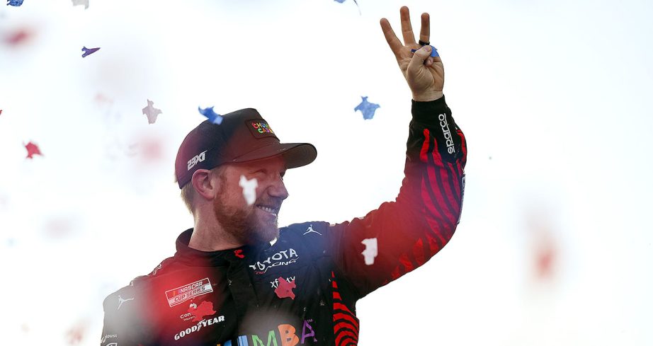 Tyler Reddick holds up three fingers in celebration.