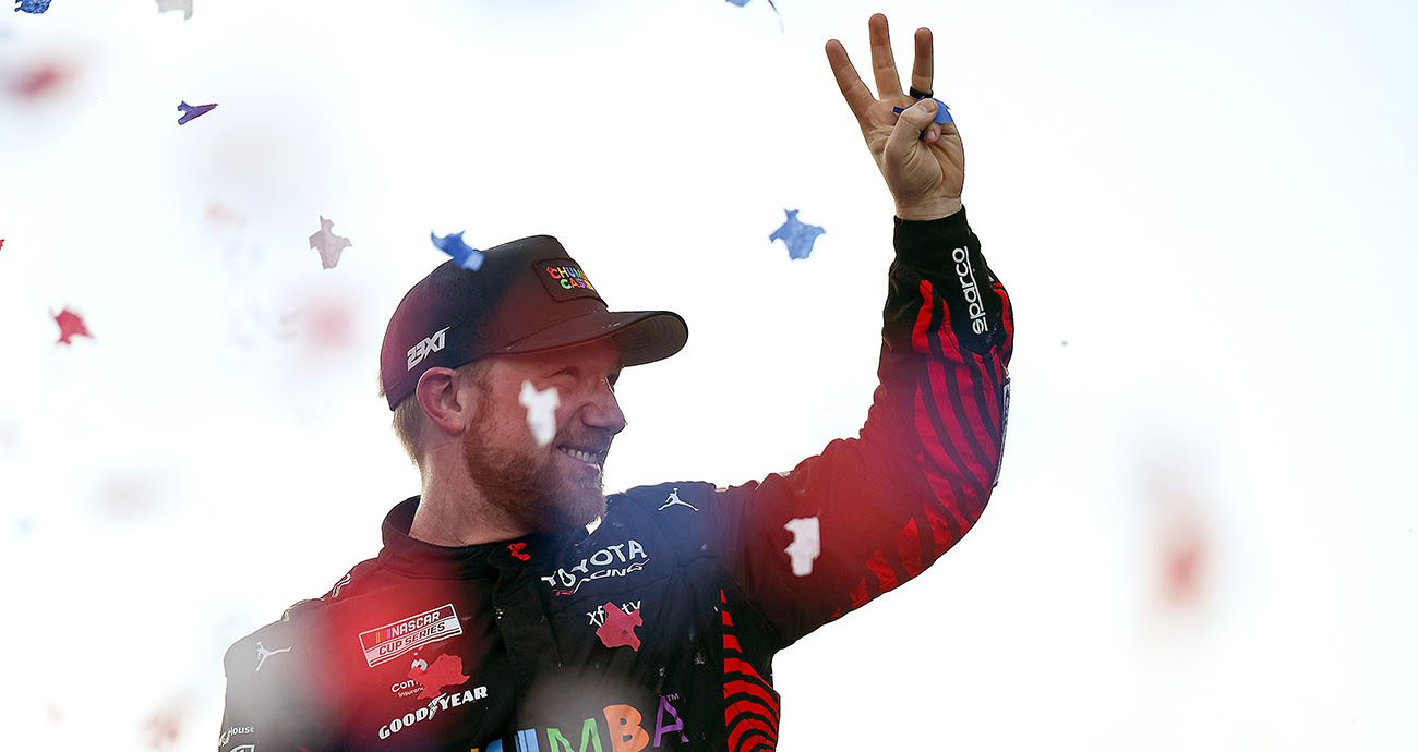 Tyler Reddick holds up three fingers in celebration.
