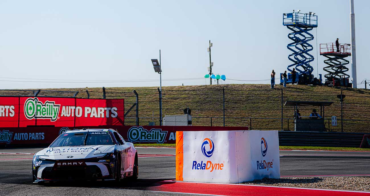 Denny Hamlin's No. 11 Toyota navigates the tire-pack barriers at the Circuit of The Americas