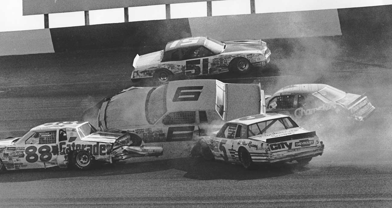 D.K. Ulrich's No. 6 nearly topples during a crash in the TranSouth 500 Cup Series race at Darlington Raceway in 1984, as Rusty Wallace (No. 88), Geoff Bodine (No. 5), Greg Sacks (No. 51) and Dick Brooks (No. 90) pile in.