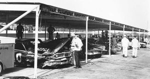 Cale Yarborough’s No. 10 Ford sits in the garage area of Darlington Raceway along with four other cars eliminated in early crashes in 1965 action