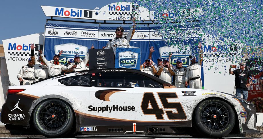 Tyler Reddick celebrates in Victory Lane at Kansas Speedway.