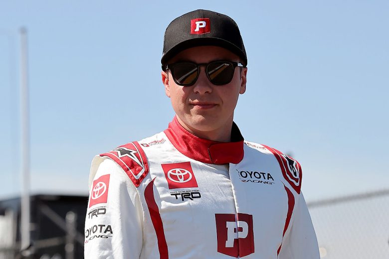 Christopher Bell looks on.