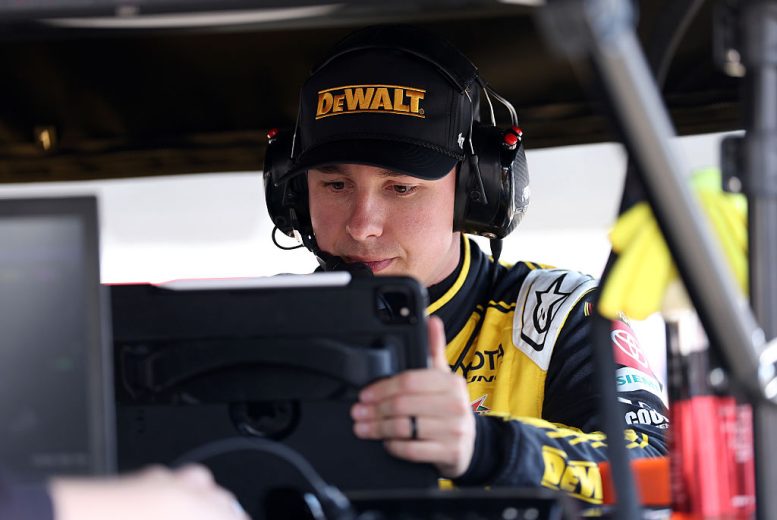 Christopher Bell looks on.
