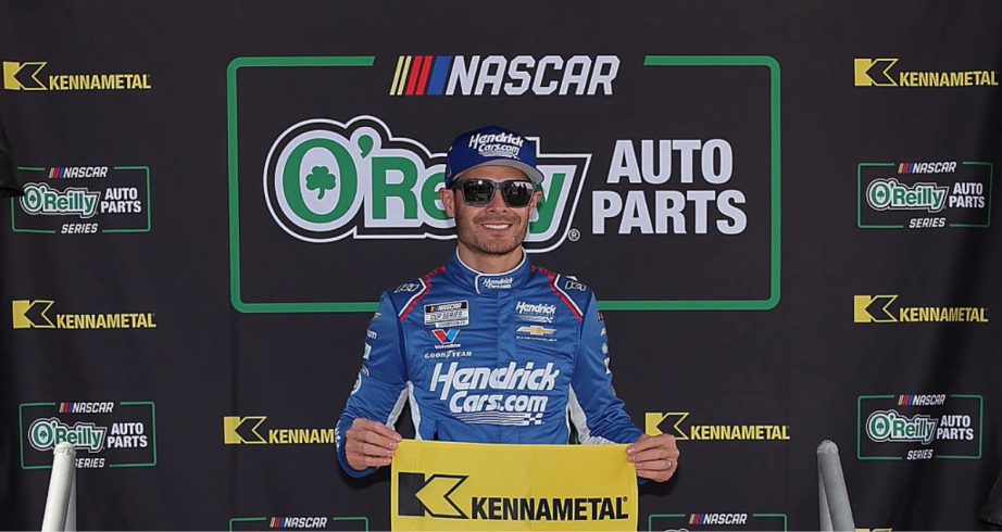 Kyle Larson celebrates after winning the pole at Darlington.