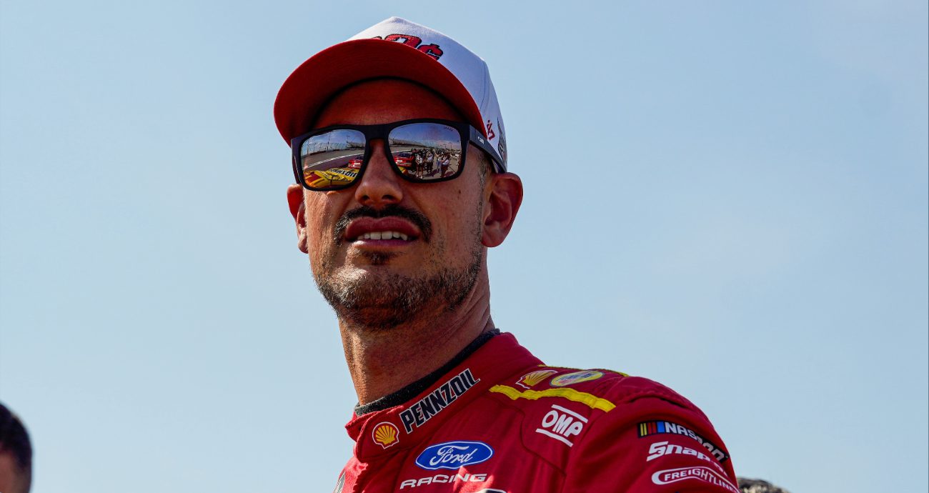 Joey Logano looks on.