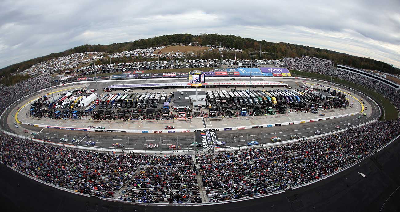 The Cup Series field rounds Martinsville Speedway, shown in a panoramic view during October 2025 action.