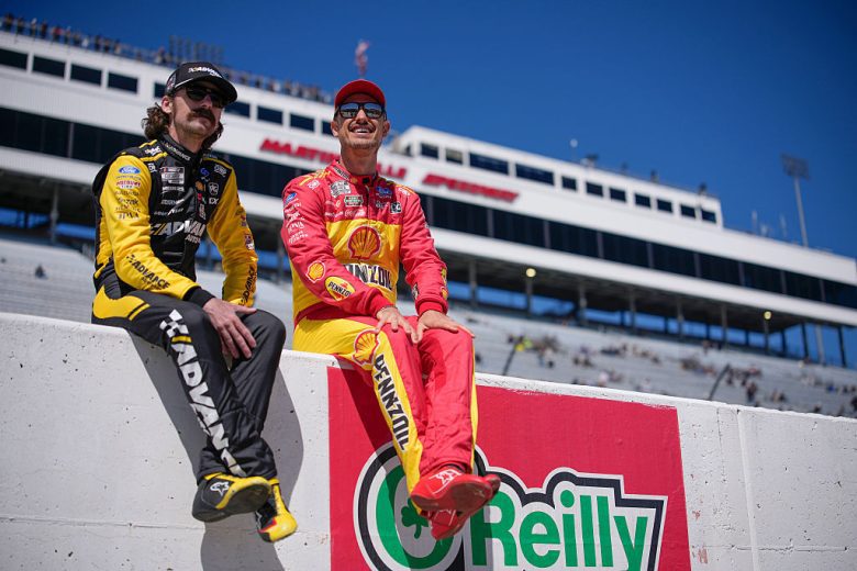 Ryan Blaney and Joey Logano look on.
