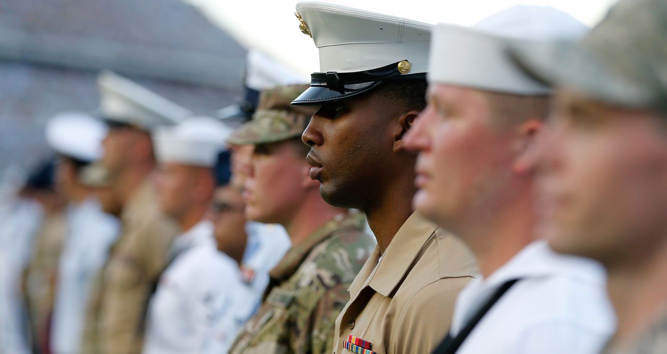 United States military service members line up before a NASCAR Cup Series race.