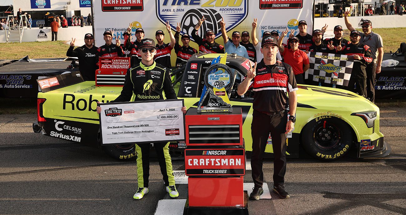 Corey Heim holds up check.