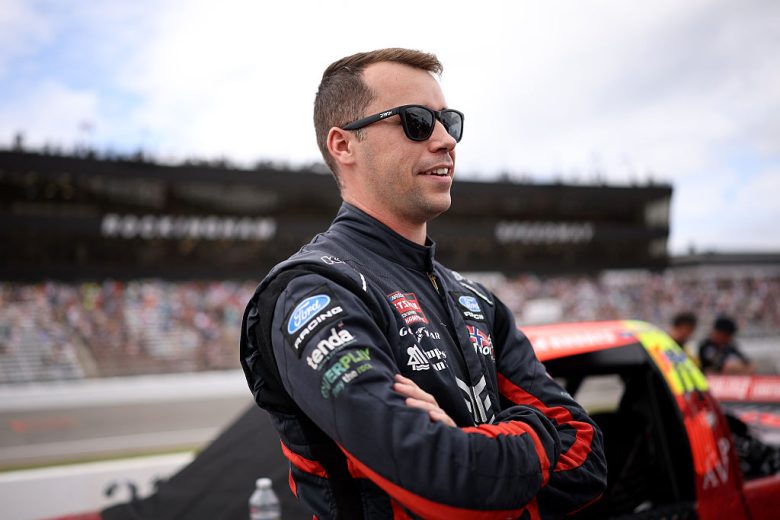 Ben Rhodes looks on.