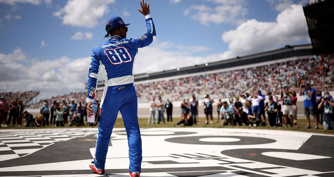 Rajah Caruth waves to fans before an O'Reilly Auto Parts Series race.