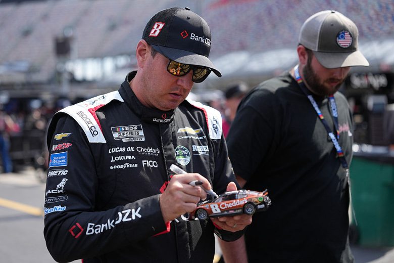 Kyle Busch signs a diecast.