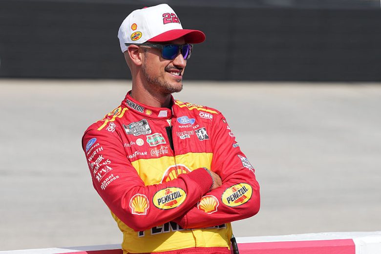 Joey Logano looks on.