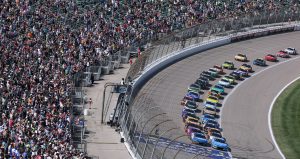 NASCAR Cup Series cars race to the start-finish line on May 11, 2025 at Kansas Speedway.
