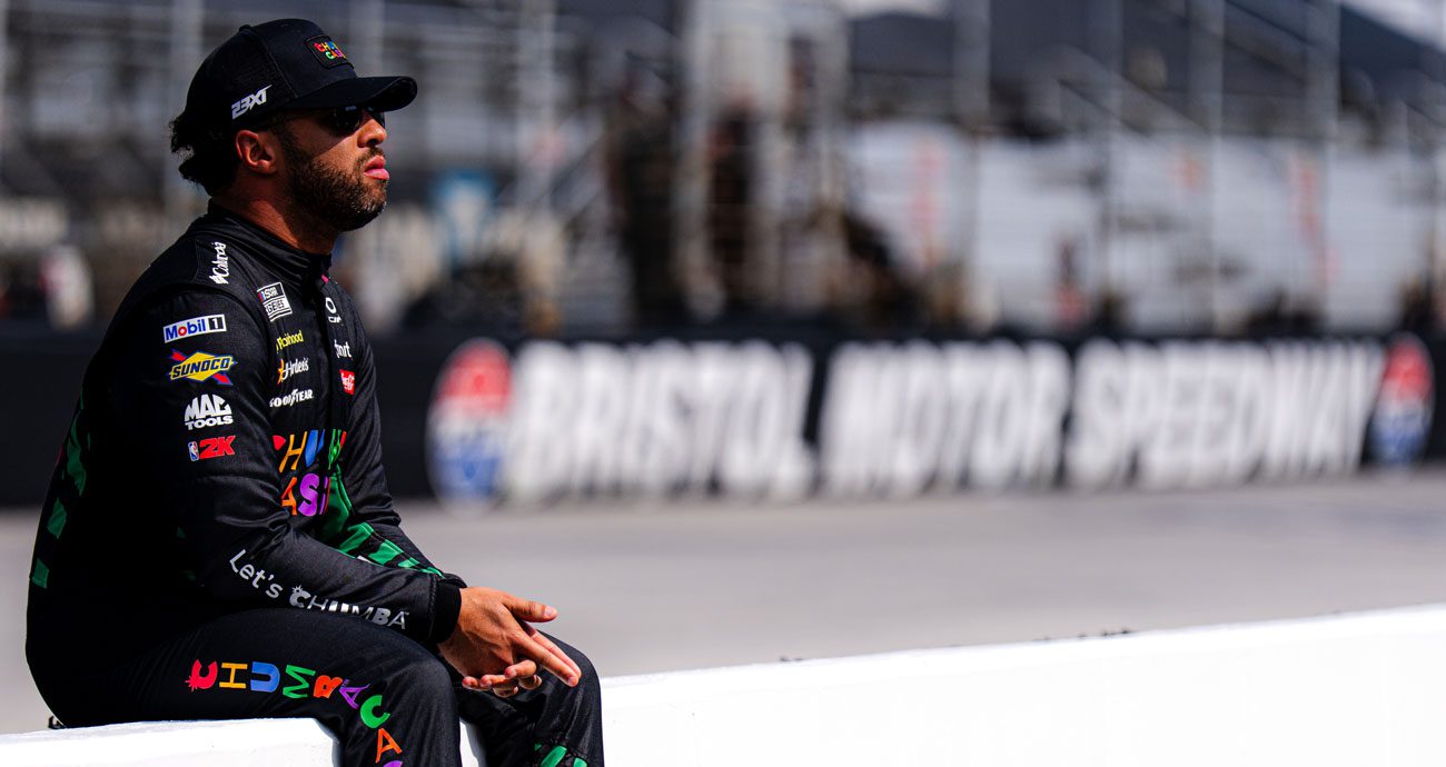 Bubba Wallace sits on pit wall at Bristol before NASCAR Cup Series action.
