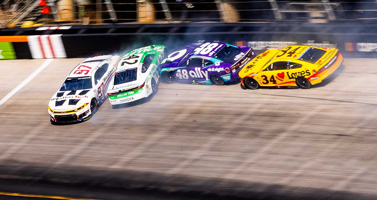 The cars of Shane van Gisbergen (97), John Hunter Nemechek (42), Alex Bowman (48) and Todd Gilliland (34) crash through the banking at Bristol Motor Speedway