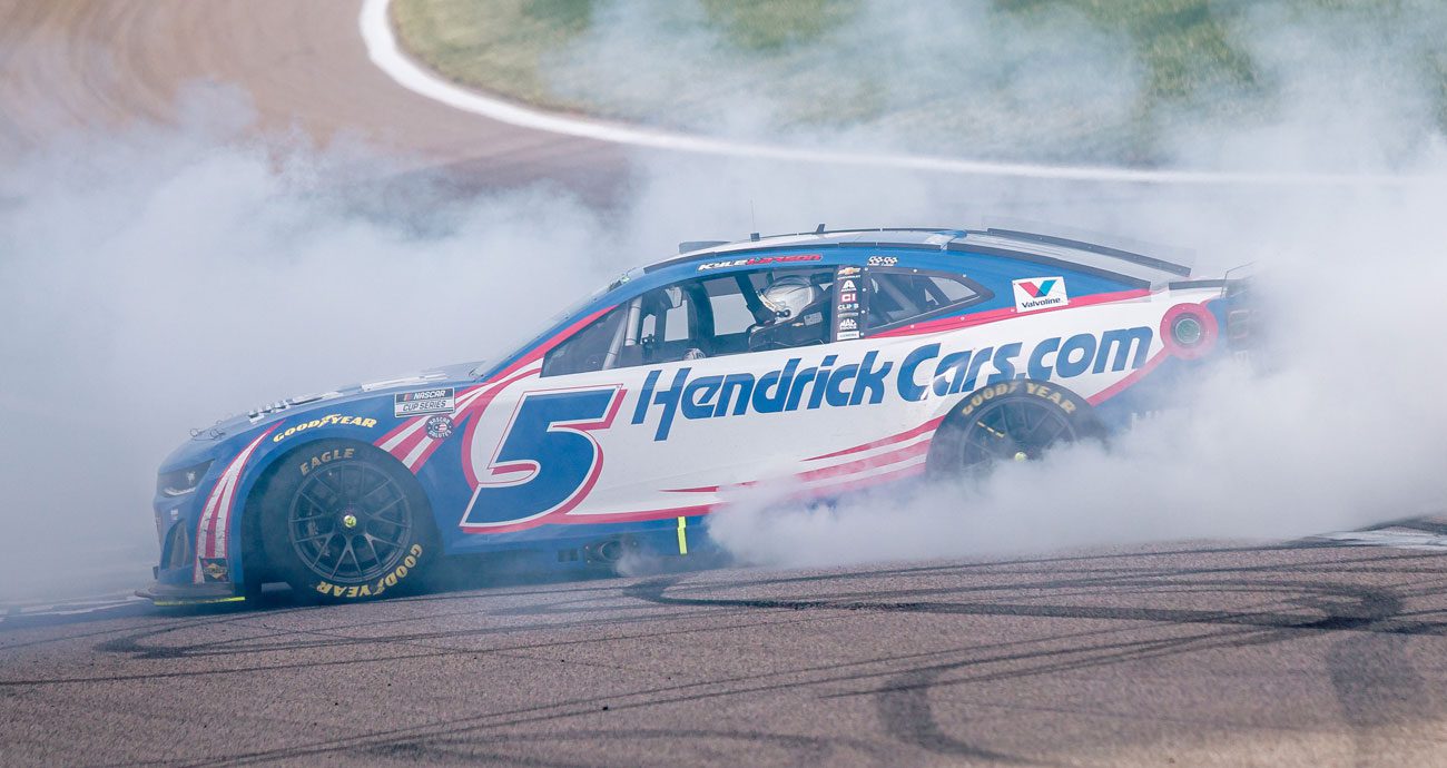 Kyle Larson performs a burnout after winning at Kansas in 2025.