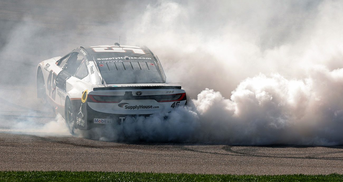 Tyler Reddick does a victory burnout in the No. 45 23XI Racing Toyota at Kansas Speedway.