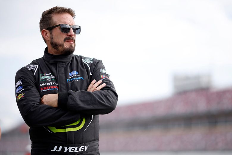 JJ Yeley looks on.