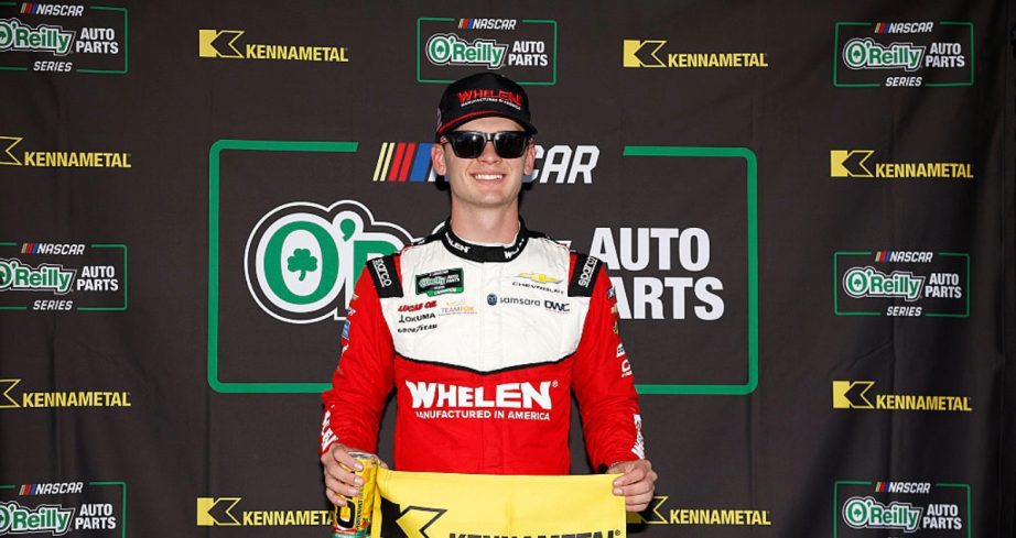 Jesse Love celebrates after winning the pole at Talladega.