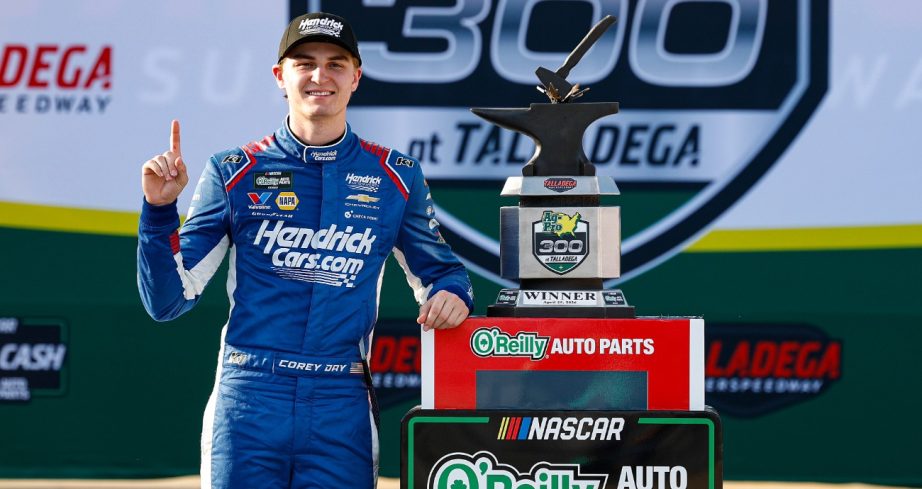 Corey Day poses in Victory Lane with the trophy.