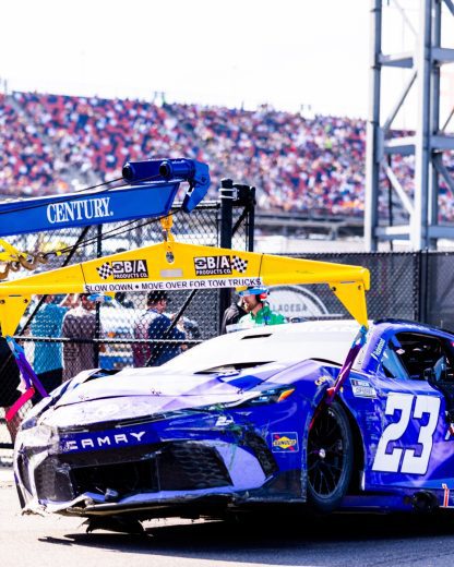 The No. 23 Toyota gets towed following a NASCAR Cup Series wreck at Talladega Superspeedway.