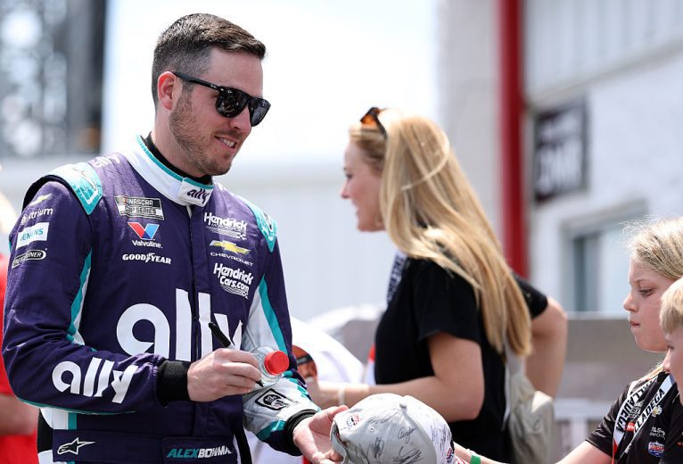 Alex Bowman signs autographs at Talladega Superspeedway.