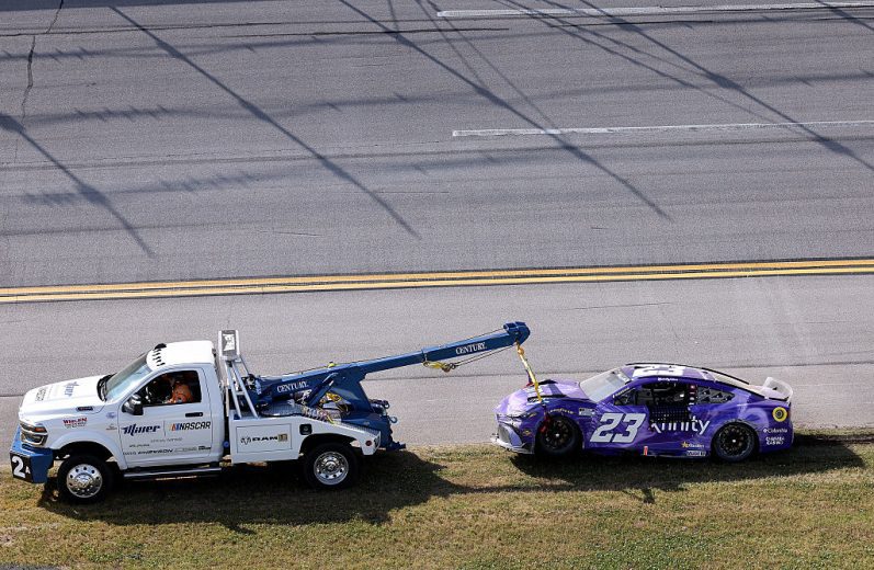 The No. 23 Toyota gets towed following a NASCAR Cup Series wreck at Talladega Superspeedway.