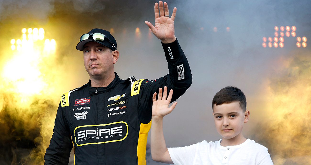 Kyle Busch, driver of the #07 Gainbridge Chevrolet, and his son, Brexton Busch wave to fans onstage during driver intros prior to the NASCAR Craftsman Truck Series Rackley Roofing 200 at Nashville Superspeedway on May 30, 2025 in Lebanon, Tennessee. 
